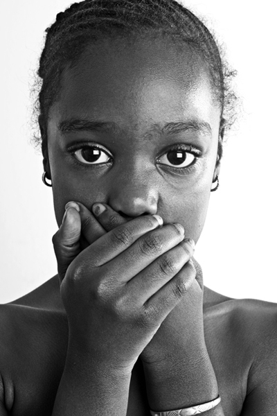 Girl covering her mouth with her hands