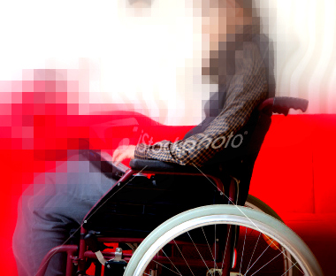 The original photo of the man in the wheelchair is modified so that the wheelchair is blurred, pixelated, and distorted.