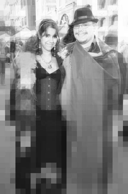 The original photo of the couple is in black and white so the rainbows are not recognizable. It is also blurred and pixelated with their faces being the only clear part of the picture.