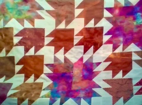 Quilt of many colors and geometric shapes